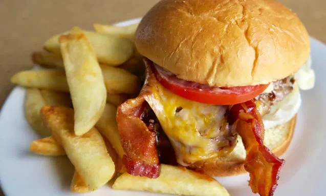 Classic bacon cheeseburger and golden, thick-cut french fries.