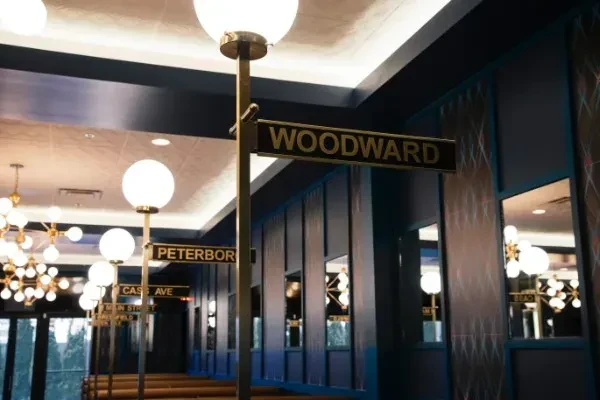 Restaurant interior with blue walls, street signs, and spherical lights.