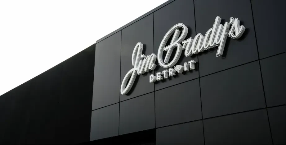 Sleek "Jim Brady's DETROIT" sign on a dark, modern building.
