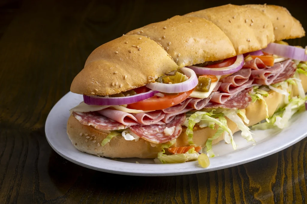 Loaded hoagie sub sandwich with meats, cheese, and fresh vegetables.