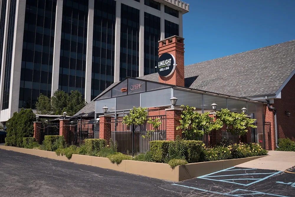 Limelight Grill & Bar restaurant exterior, brick building, patio, and landscaping.