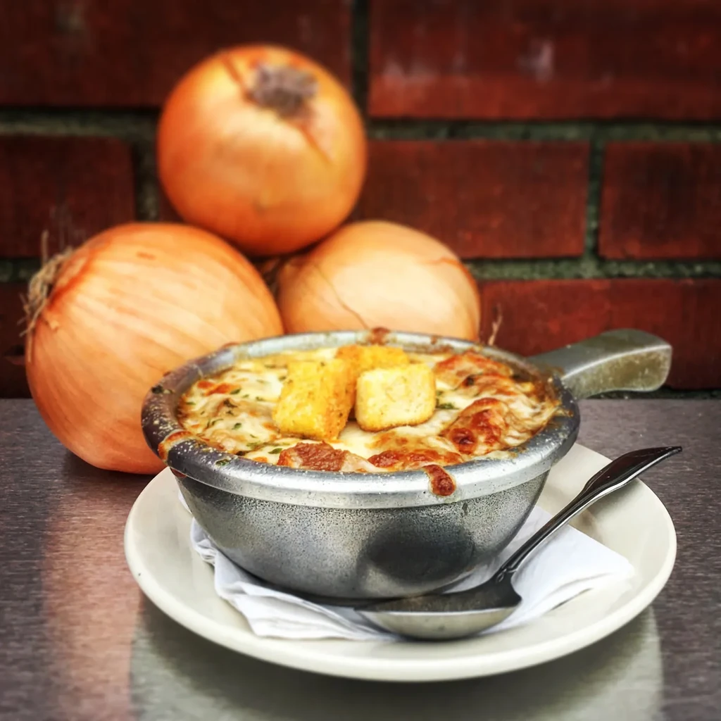 Rustic French onion soup with melted cheese, croutons, and onions.