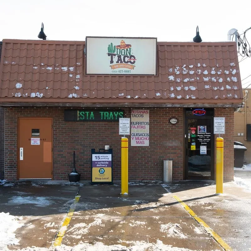 Brown brick Don Taco restaurant exterior on a snowy day.
