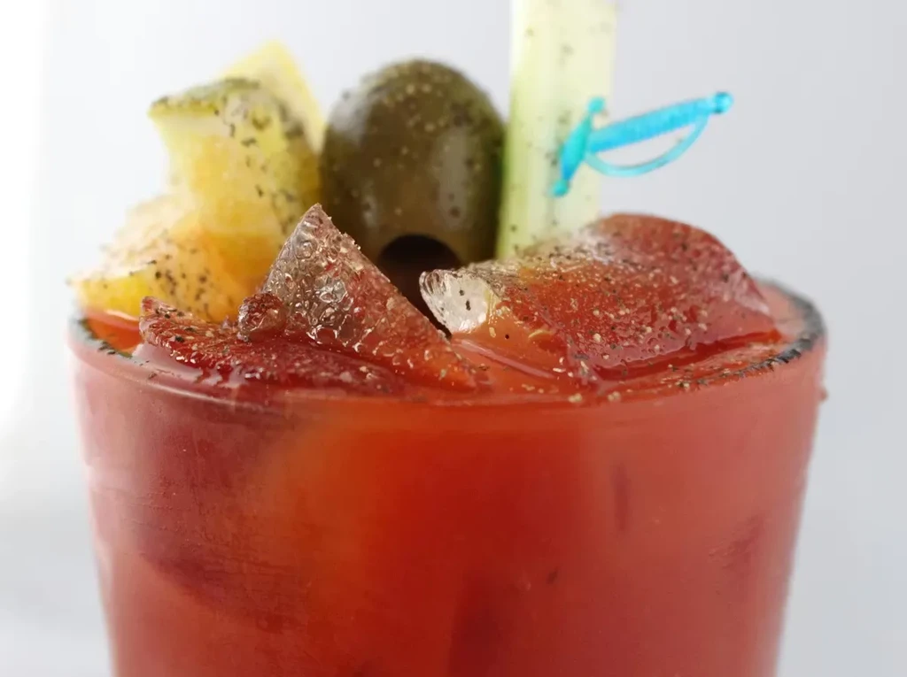 Garnished Bloody Mary with olive, citrus, celery, and a spiced rim.