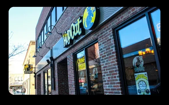 HopCat's red brick building with a prominent cat-on-globe logo sign.