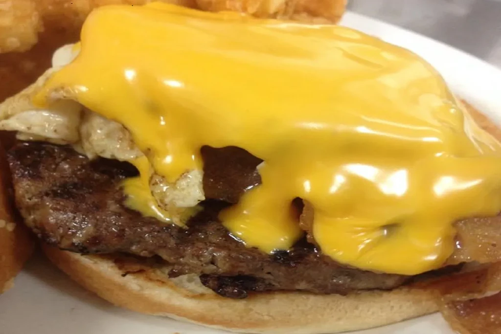 Grilled patty, fried egg, and melted cheese on a toasted bun.