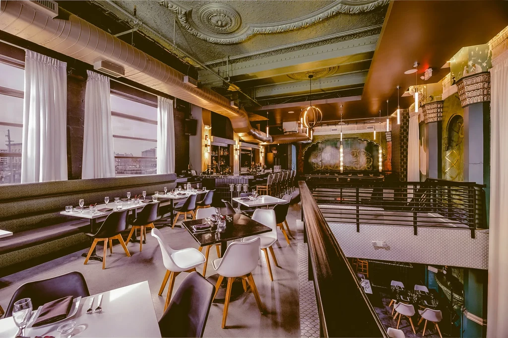 Sophisticated, multi-level restaurant interior with diverse seating and architectural details.