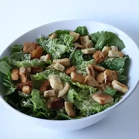 Fresh Caesar salad with romaine, croutons, and Parmesan.