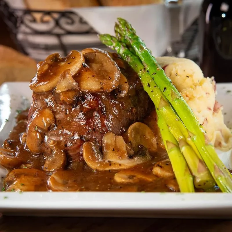 Steak, rich mushroom sauce, green asparagus, and mashed potatoes.