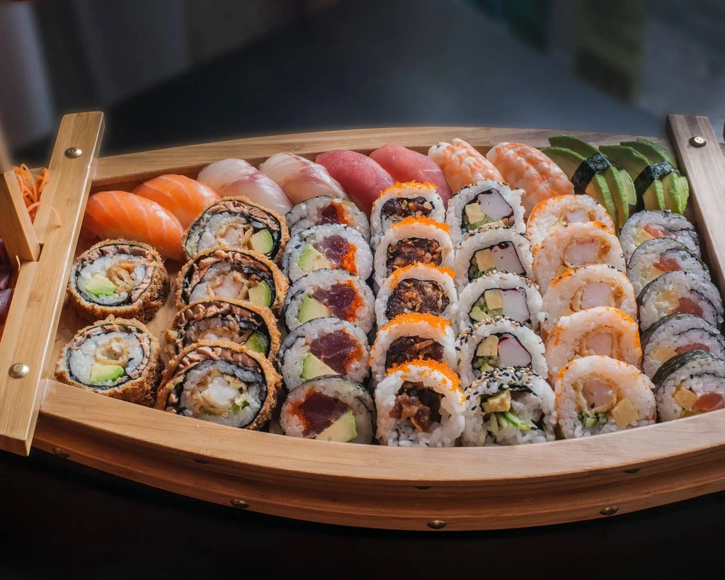 Extensive fresh sushi and sashimi in a wooden boat platter.