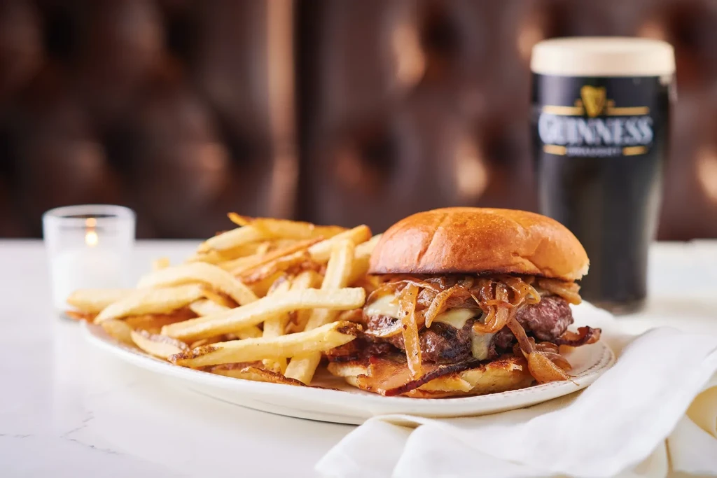 Gourmet burger with caramelized onions, fries, and Guinness stout.