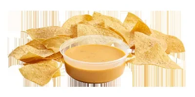 Tortilla chips surrounding a clear container of smooth queso.