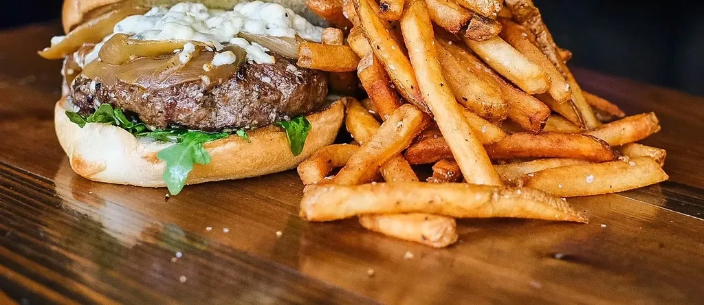 Thick gourmet burger with blue cheese, caramelized onions, and seasoned fries.