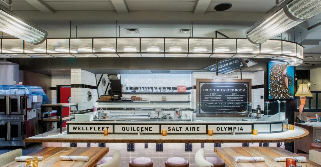 A modern restaurant interior with a prominent oyster bar.