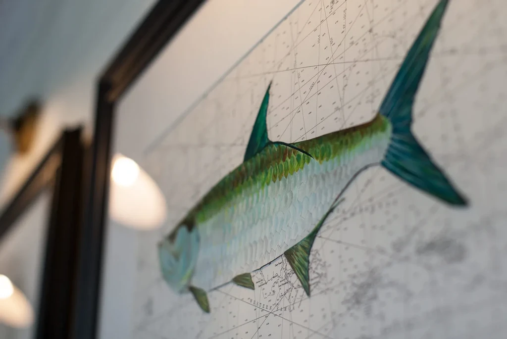 Close-up of framed detailed fish illustration on a nautical chart.