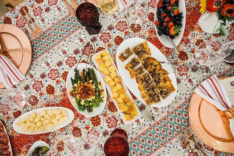 Overhead view of an elegant dining table laden with various dishes.