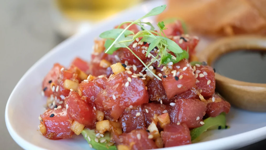 Tuna poke with avocado, mango, sesame, and microgreens.