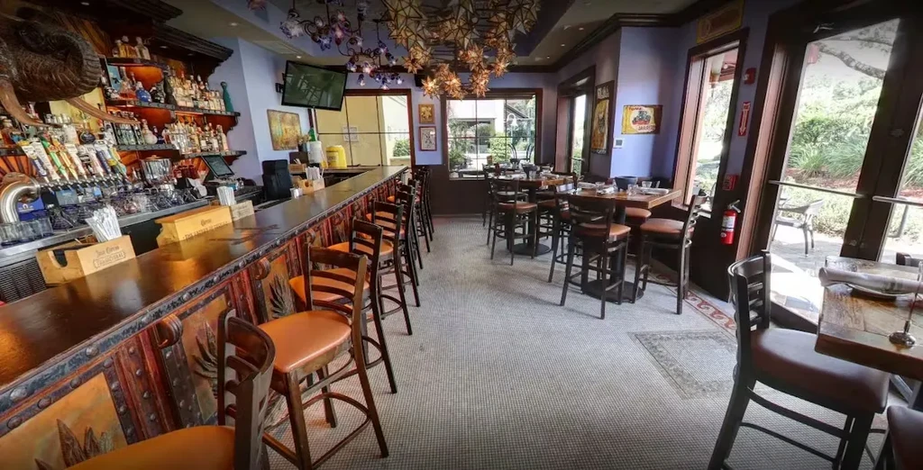 Empty restaurant bar and dining area with Southwestern-inspired decor.