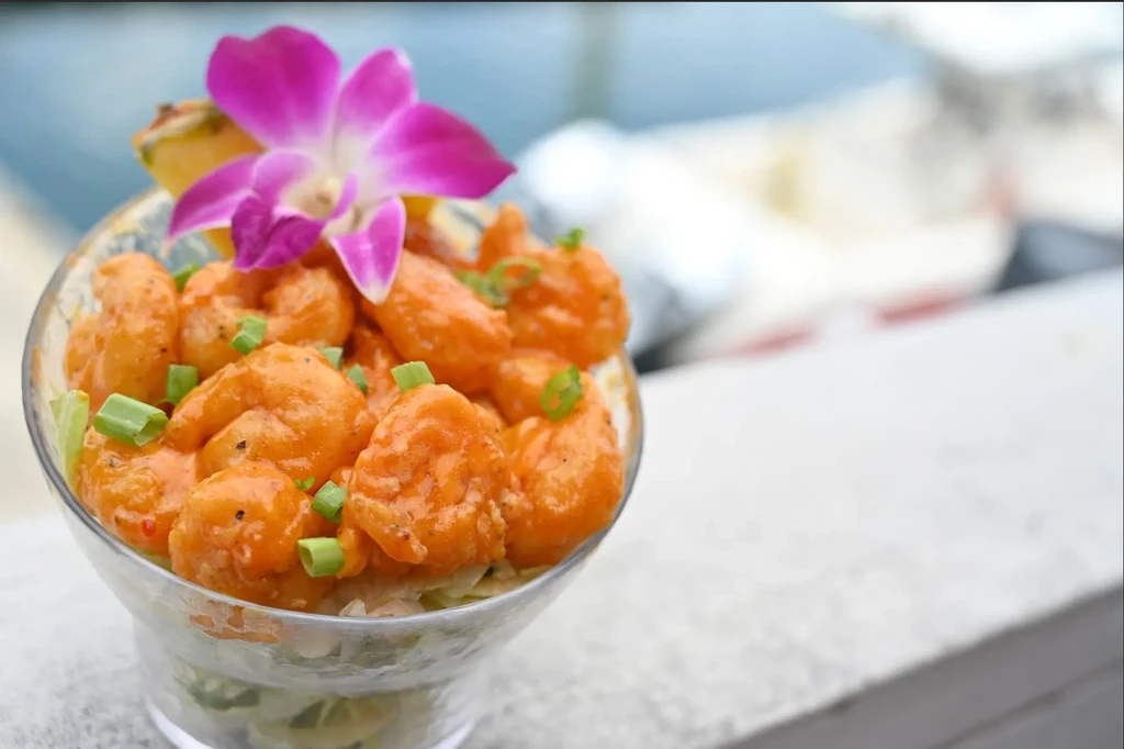 Crispy orange sauced shrimp with green onions, lettuce, orchid, and pineapple.