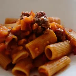 Rigatoni pasta with a chunky meat and vegetable ragu.