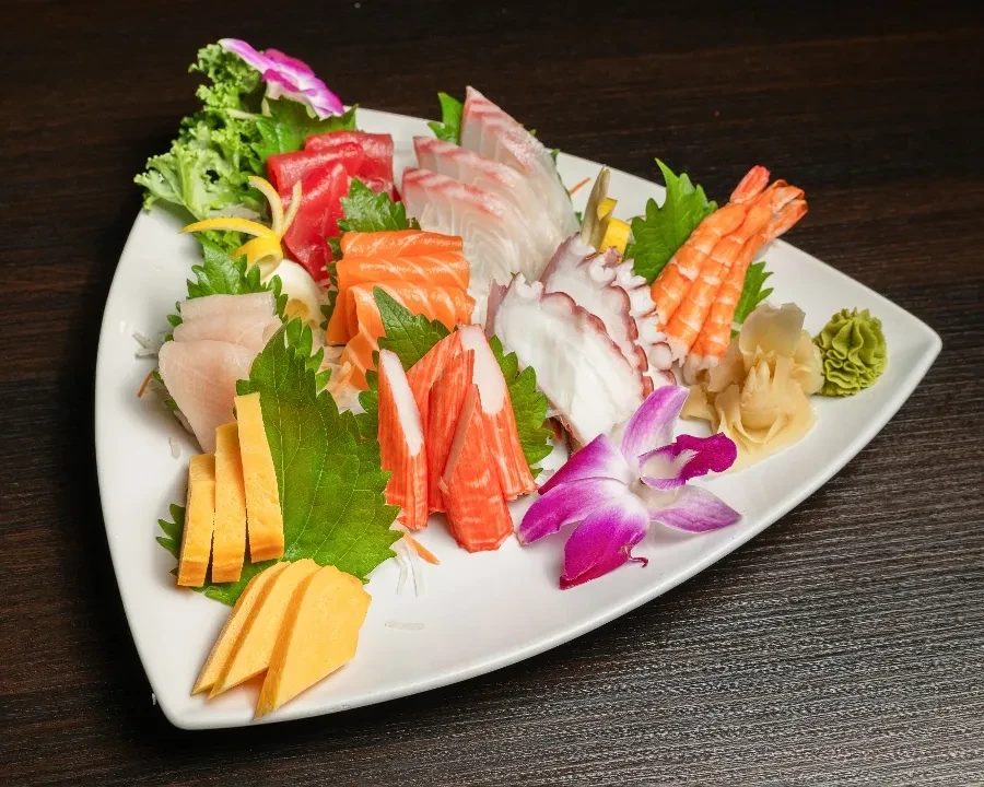Vibrant platter of sashimi, seafood, tamago, and condiments.