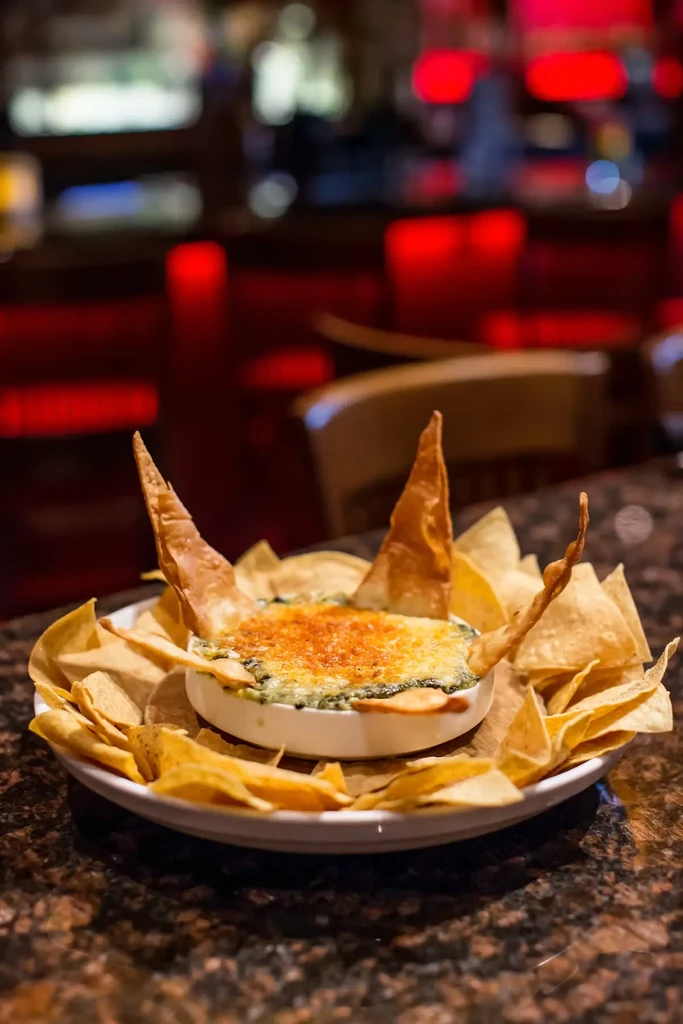 Hot golden-brown bubbly dip with golden tortilla chips.