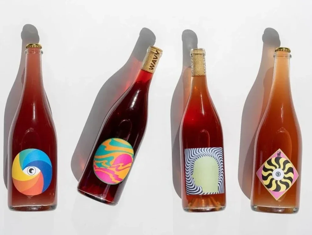 Four unique bottles with colorful labels and shadows on a white background.