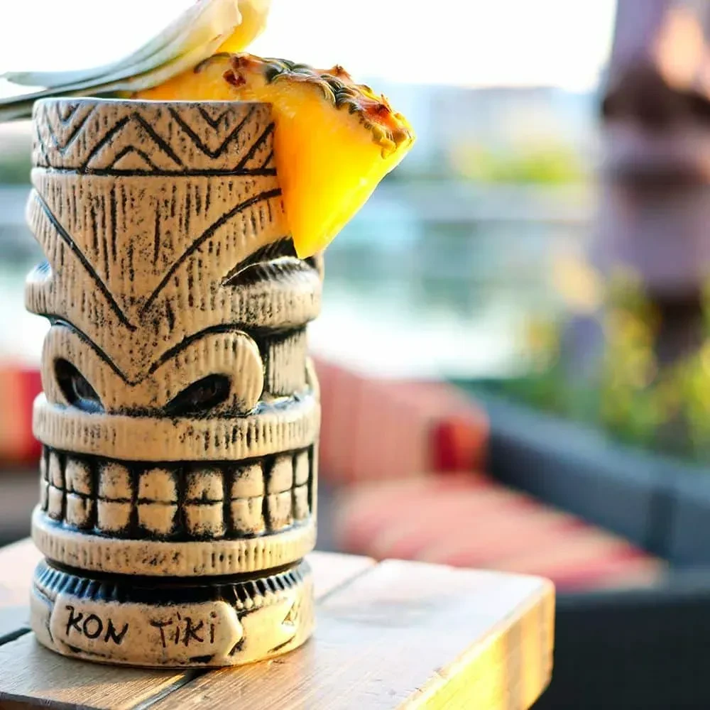 Kon Tiki tiki mug holding a tropical drink with pineapple garnish.