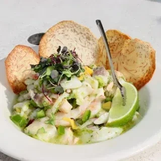 Ceviche with shrimp, fish, vegetables, lime, and plantain chips.