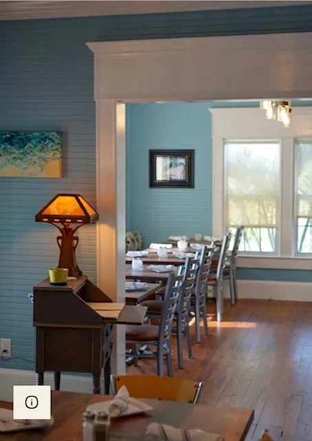 Cozy restaurant interior with two dining rooms and a stained-glass lamp.