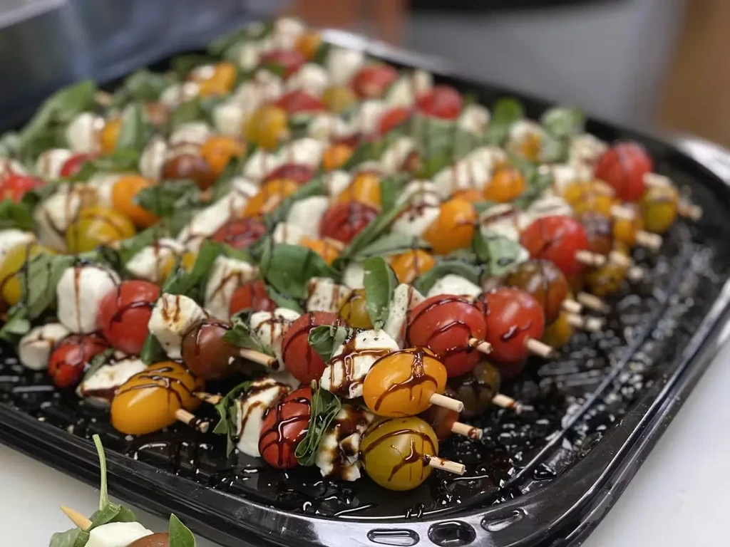 Colorful Caprese skewers with mozzarella, tomatoes, basil, and balsamic glaze.