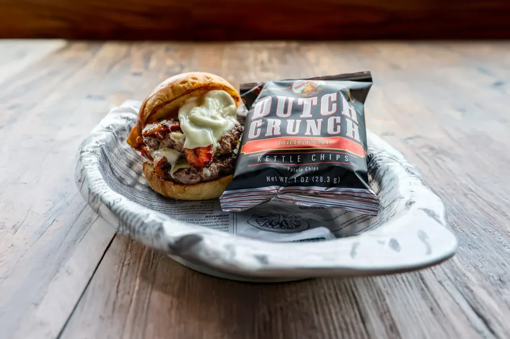 Double-patty burger with bacon, cheese, sauce, and Dutch Crunch chips.