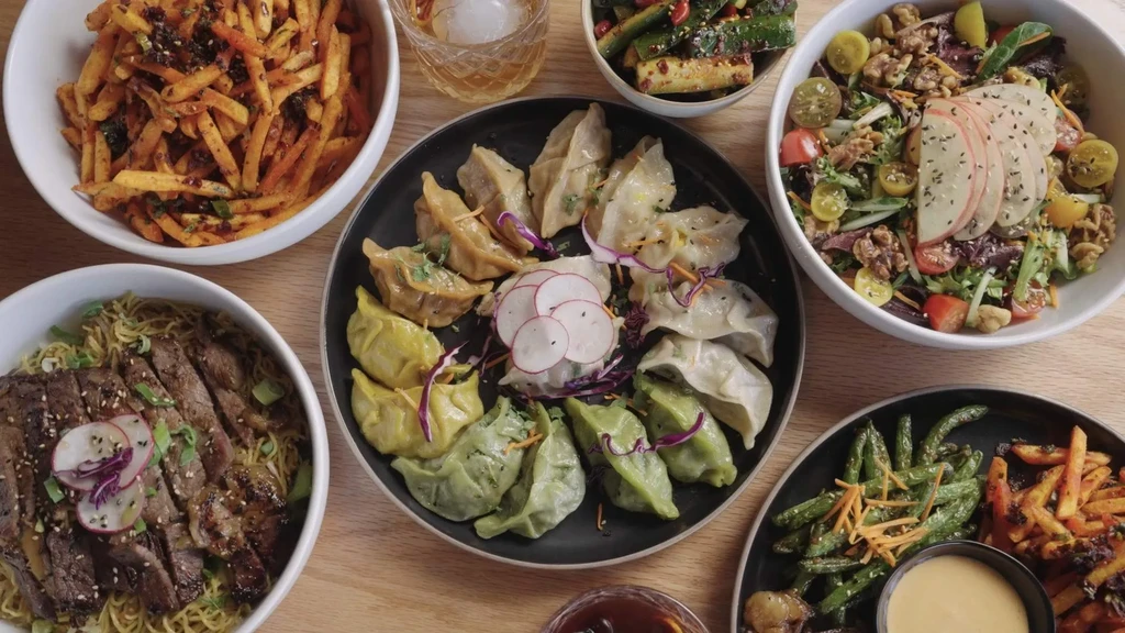 Overhead view of a colorful spread of Asian dishes and drinks.