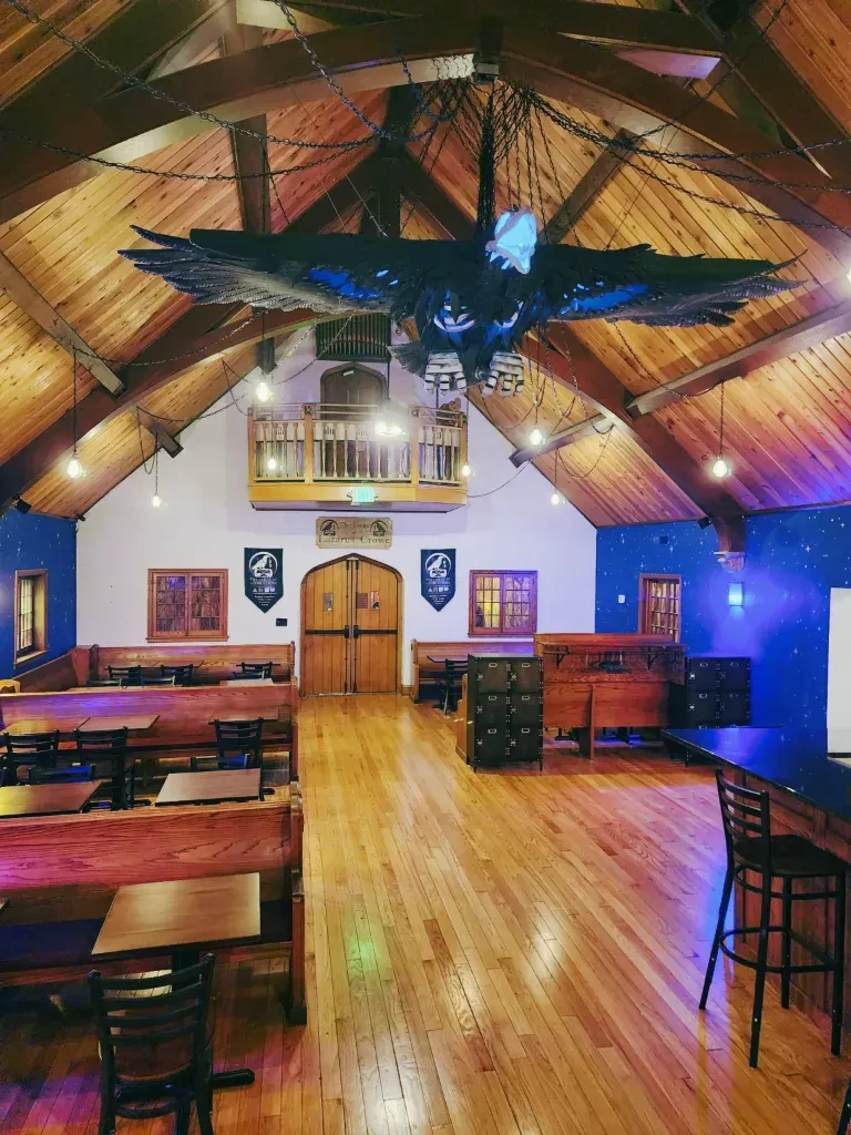 Vaulted restaurant interior with dragon sculpture and star-patterned walls.