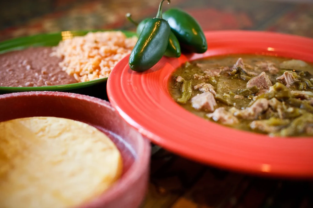 Green Mexican stew with jalapeños, beans, rice, and tortillas.