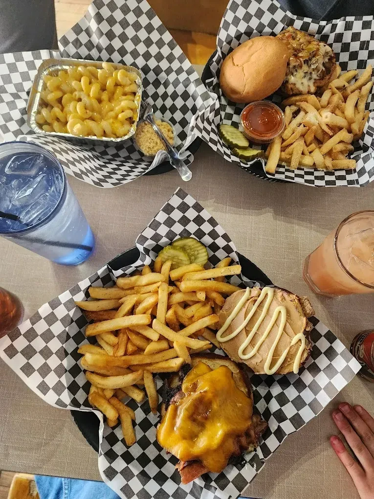 Overhead view of a table laden with American comfort food and drinks.