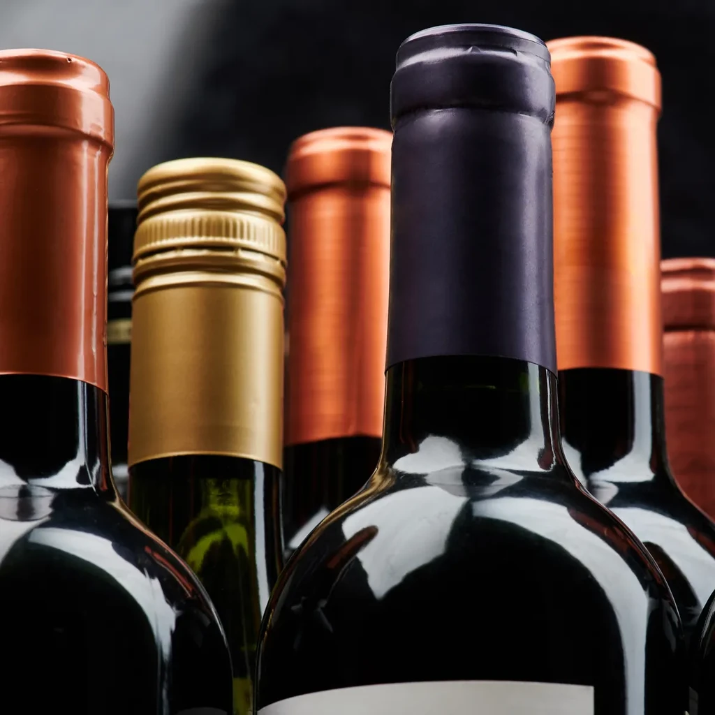 Five wine bottles with bronze, gold, and purple foils.