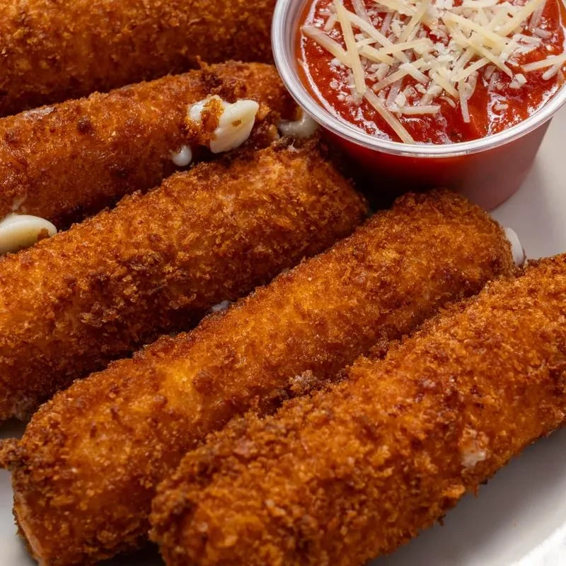 Crispy mozzarella sticks with melted cheese and cheesy marinara.