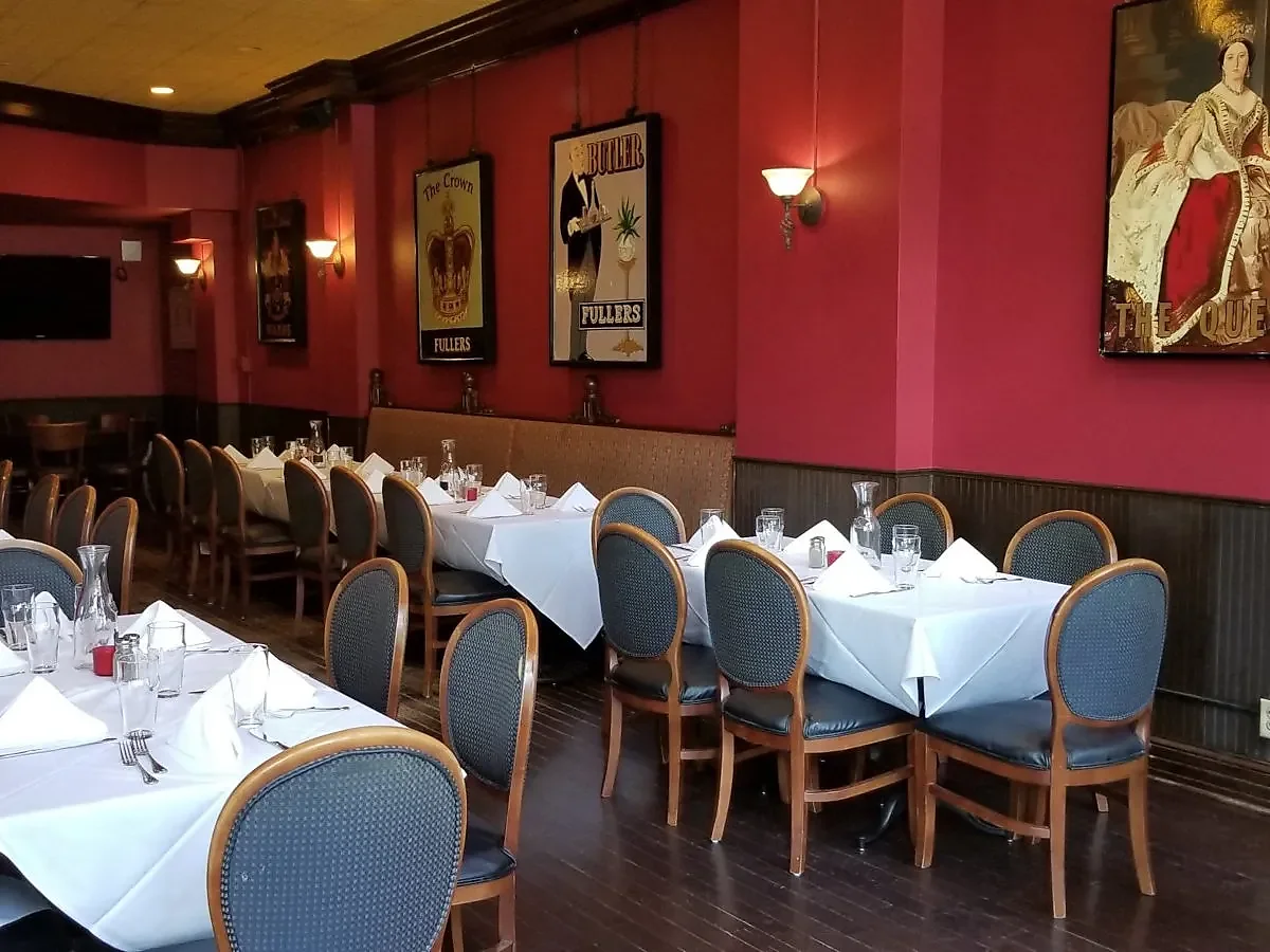 Red dining room with British pub posters and set tables