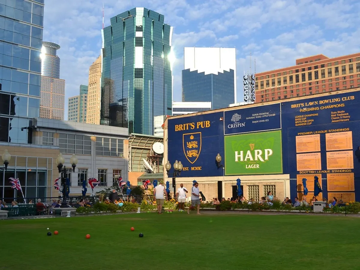Rooftop lawn bowling green with Minneapolis skyline and pub signage