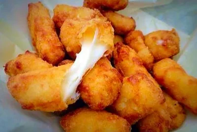 Golden-brown fried cheese, one piece broken with melted, stretchy cheese.