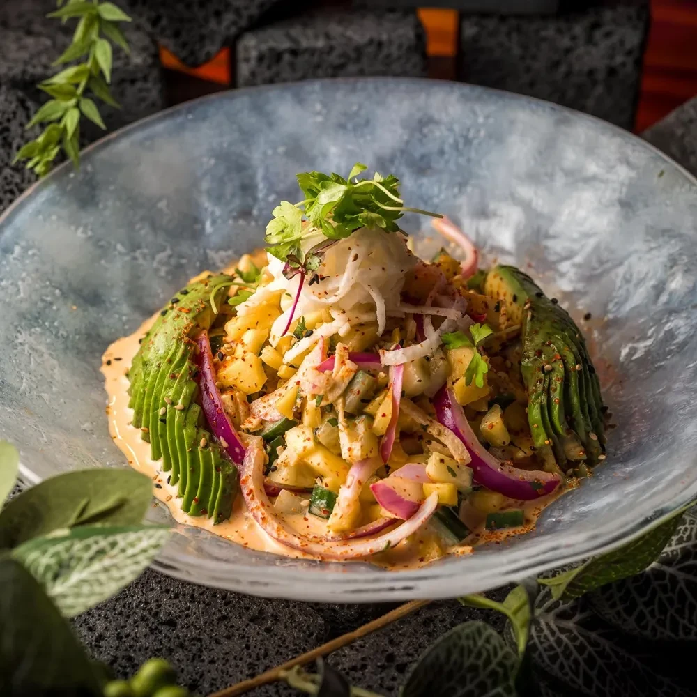 Colorful poke-style dish with avocado, mango, and fresh cilantro.