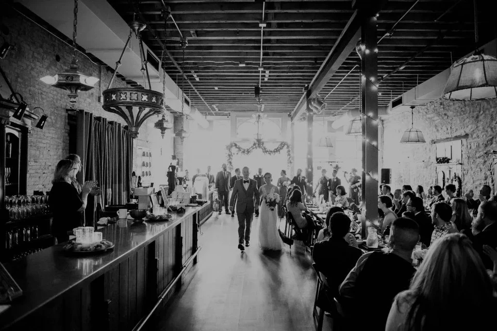 Black and white wedding reception in an industrial-chic event space.