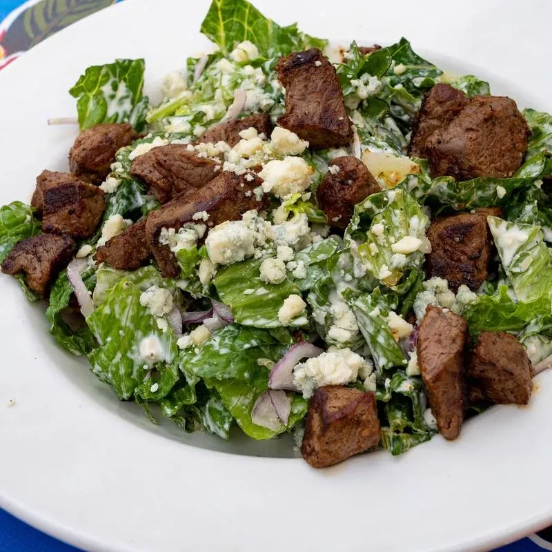 Romaine salad with steak tips, blue cheese, red onion, and creamy dressing.
