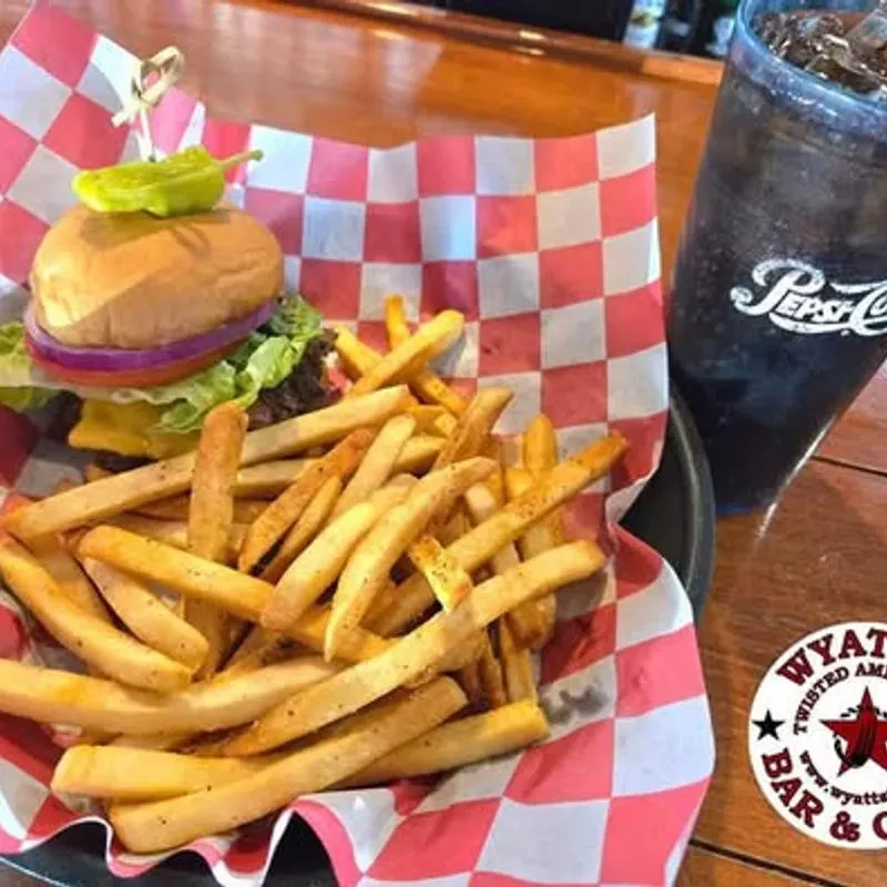 A cheeseburger, fries, and Pepsi in a basket at Wyatt's Bar.