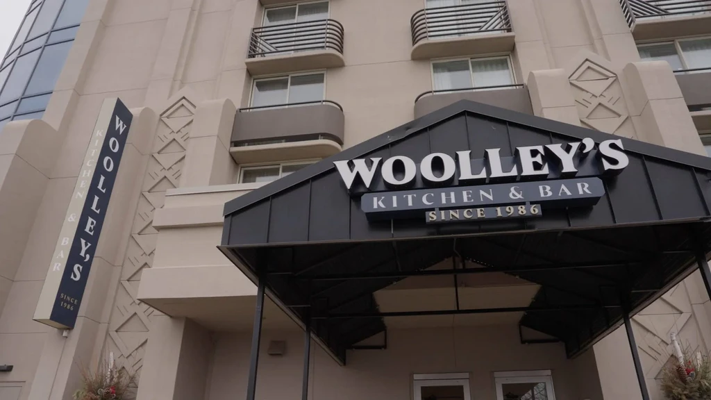 Exterior of Woolley's Kitchen & Bar with Art Deco facade.