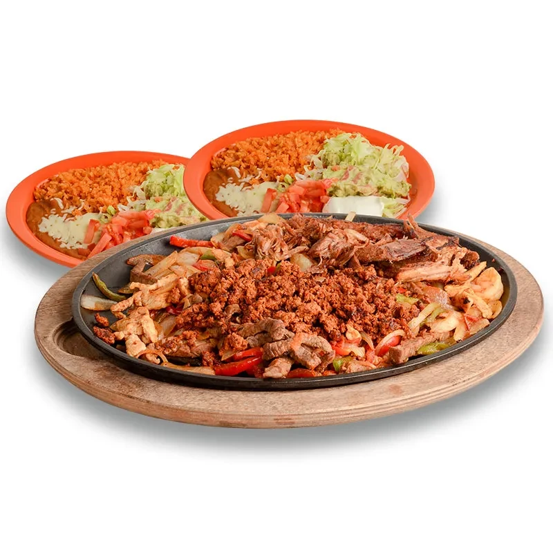 Sizzling Mexican meat and vegetable platter with rice, beans, salad.