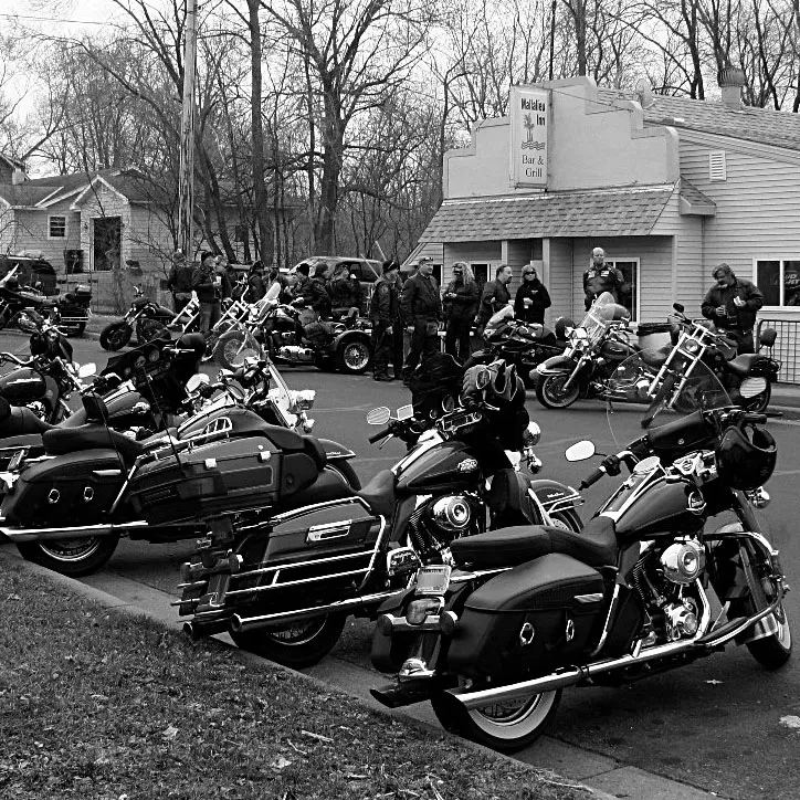 Black and white photo: Motorcycles and people gathered at Walhalla Inn.