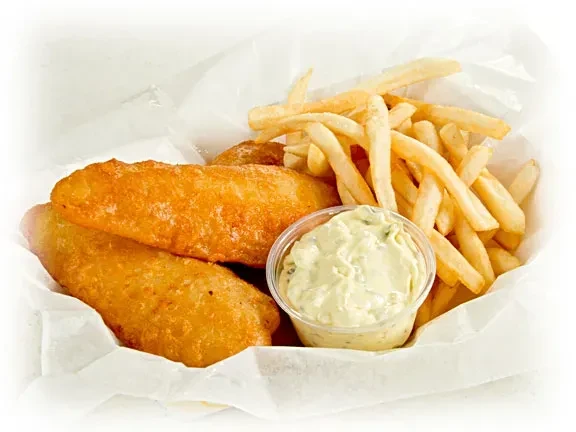 Classic fish and chips with tartar sauce in a white basket.