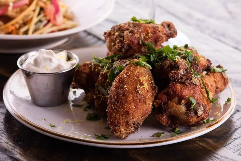 Crispy fried chicken, fresh herbs, lemon zest, and creamy dipping sauce.